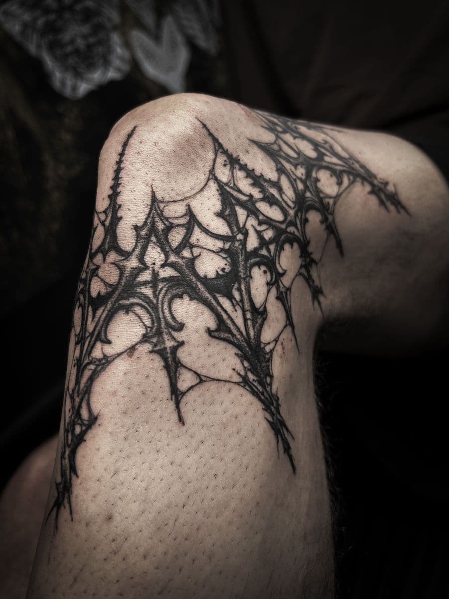 Gothic web pattern on knee
